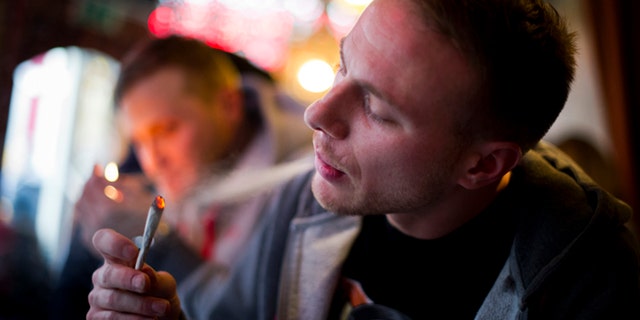 AMSTERDAM, NETHERLANDS - NOVEMBER 01: Jay, 29 years old from London, smokes cannabis in a coffee shop on November 1, 2012 in the center of Amsterdam, Netherlands. Coffee shops in the Dutch captial will remain open to tourists after its mayor, Eberhard van der Laan, decided that tourists will not be banned from the 220 coffee shops in Amsterdam where marijuana and hashish are openly sold and consumed. The decision came after the new government of the Netherlands stated that it would be up to local authorities to decide whether or not to impose a ban on cannabis. (Photo by Jasper Juinen/Getty Images)