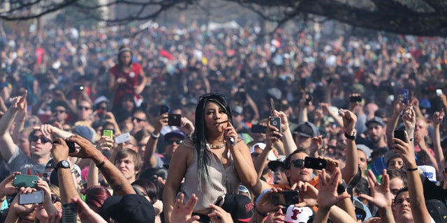 April 20, 2014: Partygoers listen to live music on the second of two days at the annual 4/20 marijuana festival in Denver. The annual event is the first 420 marijuana celebration since retail marijuana stores began selling in January 2014. (AP Photo/Brennan Linsley)