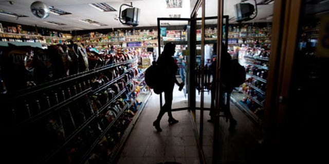 This Sept. 8, 2011 file photo shows Deborah Springs shopping in a convenience store for food items after a power outage in San Diego. There were no catastrophes caused by the widespread outage that knocked out power in a region with a population of nearly 6 million spanning both sides of the U.S.-Mexico border. But for individuals and institutions alike it was a defining moment that separated the Boy Scouts of the world from the rest of us.