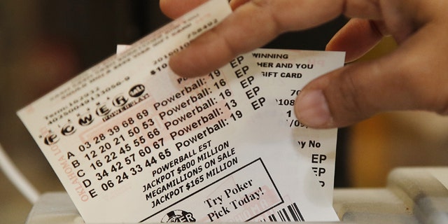 Jan. 8, 2016: Momtaz Parvin pulls Powerball lottery tickets from the printer at her store in Oklahoma City, Okla.