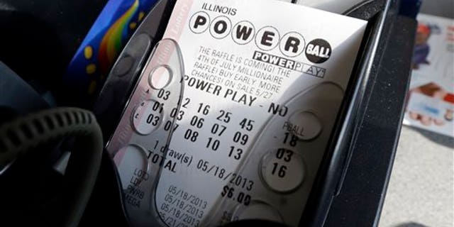FILE - A Powerball lottery ticket is printed out of a lottery machine at a convenience store in Chicago on in this May 18, 2013 file photo. According to lottery officials there were no jackpot winner for Saturday Feb. 15, 2014 drawing. The current estimated jackpot for Wednesday's drawing's jackpot is estimated at $400 million or $227.8 million in cash value. (AP Photo/Nam Y. Huh, FILE)