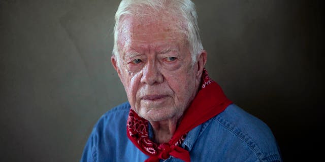 Former U.S. President Jimmy Carter pauses during an interview as he and his wife Rosalynn visit a Habitat for Humanity project in Leogane, Haiti.