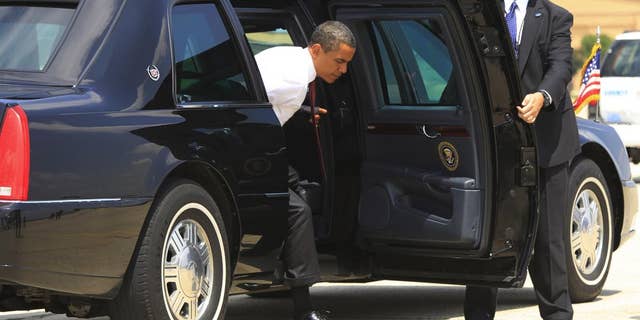President Barack Obama steps out of the armored presidential limousine at Andrews Air Force Base. (AP File Photo/Charles Dharapak)