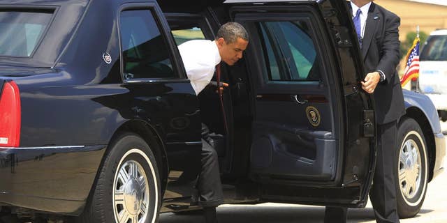 President Barack Obama steps out of the armored presidential limousine at Andrews Air Force Base. (AP File Photo/Charles Dharapak)