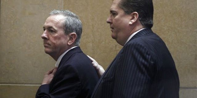 March 26: The Rev. James J. Brennan, left, arrives in the Criminal Justice Center in Philadelphia.