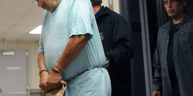 FILE--This Sept. 29, 2014 file photo, Rev. Joseph Maurizo, left, a former priest at Our Lady Queen of Angels Catholic Church in Central City, Pa., is led by US Marshals into US federal court in Johnstown,Pa., for a detention hearing on charges of engaging in illicit sex in foreign countries and possession of child pornography. A new federal indictment returned Tuesday, April 7, 2015, adds two victims and charges that Maurizio sent $8,000 to a charity to help facilitate the trips which ended in 2009. None of the alleged victims are named, but all are under 18. (AP Photo/The Tribune-Democrat, John Rucosky, FILE) MANDATORY CREDIT