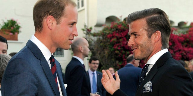 Prince William mingles with David Beckham during a private reception.