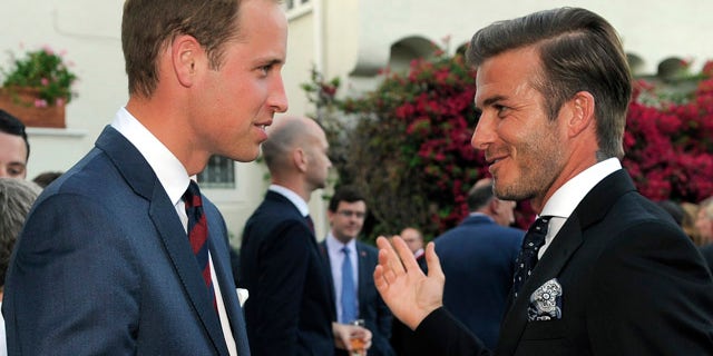 Prince William mingles with David Beckham during a private reception.