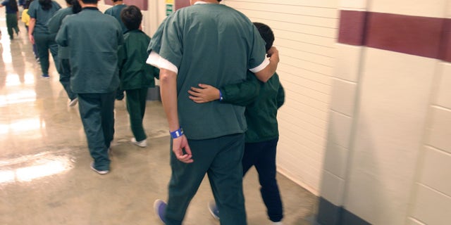 A Feb. 9, 2007 file photo provided by the Department of Homeland Security shows family detainees walking down the hall at the T. Don Hutto Residential Center in Taylor, Texas. (AP Photo/Department of Homeland Security, Charles Reed, HO, File)