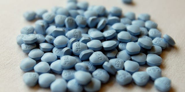 Tablets of the drug finasteride are displayed outside of a news conference given by the National Cancer Institute in Washington.