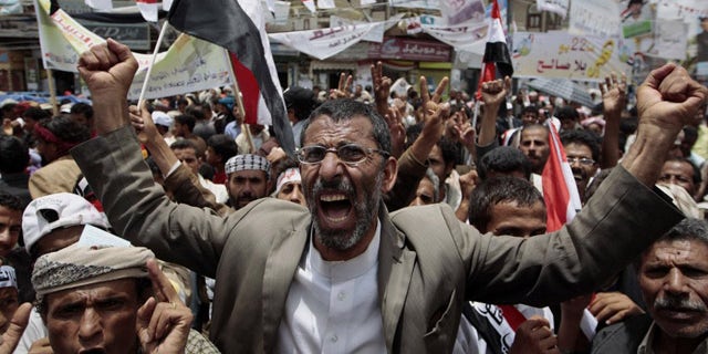 May 23: Anti-government protesters shout slogans during a rally to demand the ouster of Yemen's President Ali Abdullah Saleh. France on Monday accused Saleh of being irresponsible by refusing to sign a power transition agreement that would see him step down.