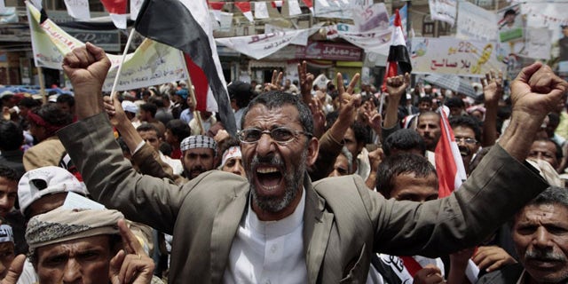 May 23: Anti-government protesters shout slogans during a rally to demand the ouster of Yemen's President Ali Abdullah Saleh. France on Monday accused Saleh of being irresponsible by refusing to sign a power transition agreement that would see him step down.