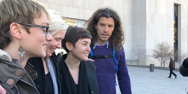 Four of the six acquitted Inauguration Day protesters, including Brittne Lawson (second to left) and Alexei Wood (far right), stood outside the courthouse following the verdict announcement.