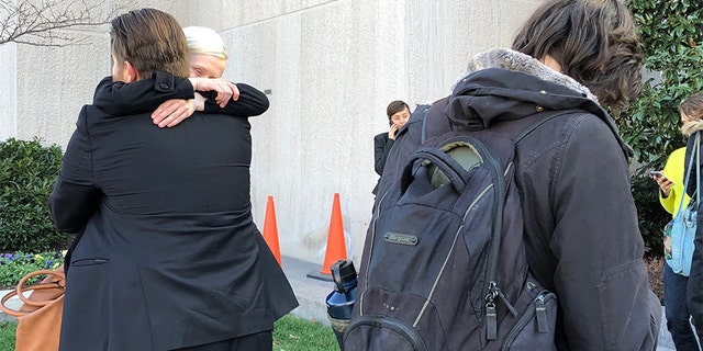 Two acquitted Inauguration Day protesters hug after the verdict's decision.
