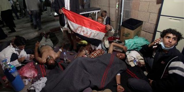 April 27: Wounded anti-government protestors lie on the ground of a field hospital following clashes with Yemeni security forces in Sanaa, Yemen.