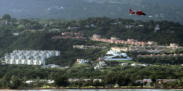 Dec. 21: A U.S. Coast Guard helicopter flies over an area believed to be the crash site of a Puerto Rico National Guard helicopter in Rio Grande, Puerto Rico. The Puerto Rico National Guard helicopter crashed into the ocean the previous day on a drug raid mission with six people aboard.