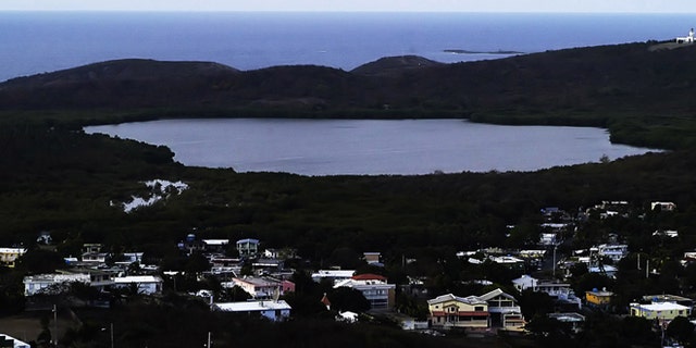 FILE - This April 1, 2005 file photo shows the Fajardo Grand Lagoon at the Nature Reserve of Las Cabezas de San Juan at dawn, about 35 miles east of San Juan, Puerto Rico. Biologists are investigating why the bioluminescent bay off the northeast coast off the Puerto Rican coast has lit up once again, Friday Dec. 6, 2013, as scientists wrap up their investigation into why it went dark last month, officials said Friday (AP Photo/Herminio Rodriguez, File)