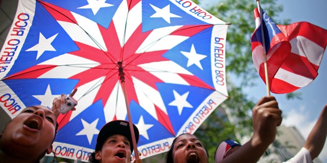 NEW YORK CITY - JUNE 8: (L-R) Stephanie Morales, Christian Ortiz and Simone Sonii cheer at the annual Puerto Rico Day Parade June 8, 2008 in New York City. The parade honoring Puerto Ricans is an annual New York City tradition and takes place along Fifth Avenue. (Photo by Yana Paskova/Getty Images)