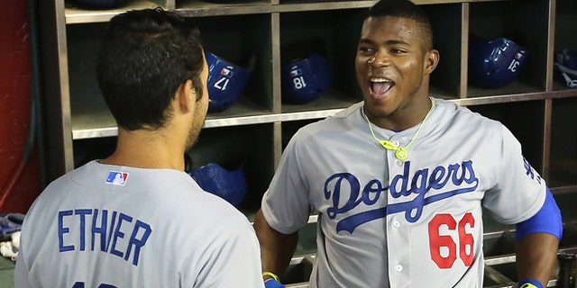 PHOENIX, AZ - APRIL 13: Yasiel Puig #66 of the Los Angeles Dodgers talks with Andre Ethier #16 in the dugout before the MLB game against the Arizona Diamondbacks at Chase Field on April 13, 2014 in Phoenix, Arizona. The Dodgers defeated the Diamondbacks 8-6. (Photo by Christian Petersen/Getty Images) *** Local Caption *** Yasiel Puig; Andre Ethier