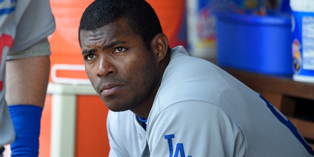 FILE - This July 21, 2016 file photo shows Los Angeles Dodgers' Yasiel Puig looking on from the dugout during a baseball game against the Washington Nationals in Washington. Puig's agent said Monday, Aug. 1, 2016 the Los Angeles Dodgers slugger expects to be sent to the minors after the club was unable to trade him at the deadline. (AP Photo/Nick Wass)