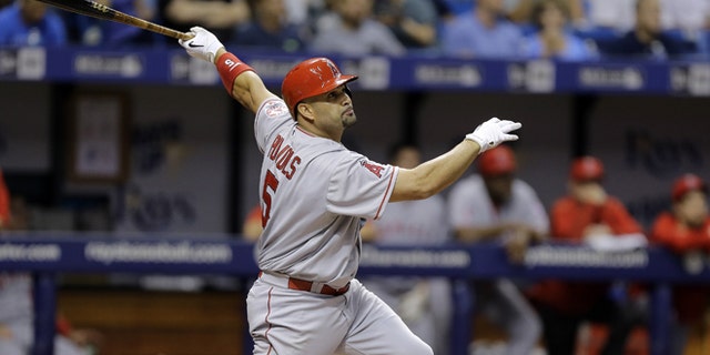 Los Angeles Angels' Albert Pujols follows the flight of his home run off Tampa Bay Rays starting pitcher Nathan Karns during the fifth inning of a baseball game Tuesday, June 9, 2015, in St. Petersburg, Fla. (AP Photo/Chris O'Meara)