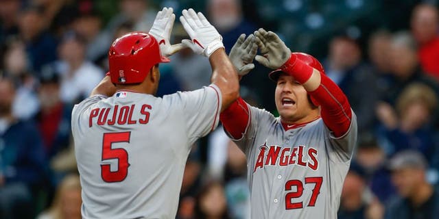 SEATTLE, WA - APRIL 08: Albert Pujols #5 of the Los Angeles Angels of Anaheim is congratulated by Mike Trout #27 after hitting a two-run homer in the first inning against the Seattle Mariners at Safeco Field on April 8, 2015 in Seattle, Washington. (Photo by Otto Greule Jr/Getty Images)