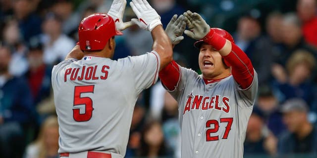 SEATTLE, WA - APRIL 08: Albert Pujols #5 of the Los Angeles Angels of Anaheim is congratulated by Mike Trout #27 after hitting a two-run homer in the first inning against the Seattle Mariners at Safeco Field on April 8, 2015 in Seattle, Washington. (Photo by Otto Greule Jr/Getty Images)