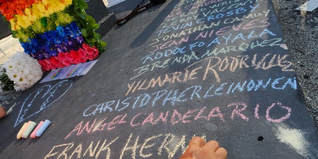 Edwin Rodriguez writes the names of the victims of the Pulse Nightclub shooting at the front of the nightclub building on June 21, 2016 in Orlando, Florida. The Orlando community continues to mourn the June 12 shooting at the Pulse nightclub in what is being called the worst mass shooting in American history, Omar Mir Seddique Mateen killed 49 people at the popular gay nightclub early last Sunday. Fifty-three people were wounded in the attack which authorities and community leaders are still trying to come to terms with. (Photo by Gerardo Mora/Getty Images)