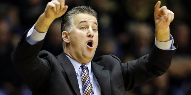 FILE - In this Jan. 12, 2014, file photo, Purdue head coach Matt Painter calls a play for his team as they play Nebraska in the second half of an NCAA college basketball game in West Lafayette, Ind. After losing 35 games over the past two seasons and finishing last in the Big Ten in 2013-14, Painter is going old-school. He wants to bring back the blue-collar, overachieving culture that made the Boilermakers so good for so many years. (AP Photo/Michael Conroy, File)