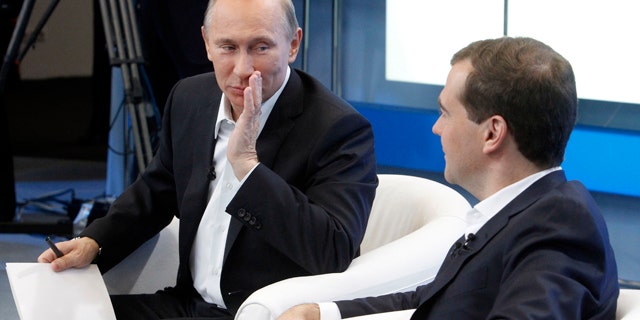 Dec. 1: Russia's President Dmitry Medvedev, right, and Prime Minister Vladimir Putin meet with supporters in Moscow.