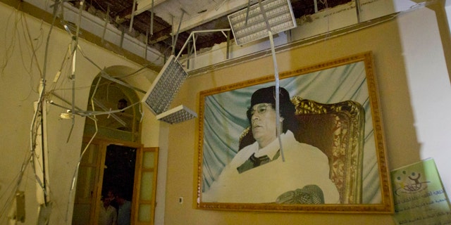 April 30: In this photo made on a government organized tour, a portrait of Moammar Gadhafi is seen inside damaged official building following an airstrike in Tripoli, Libya.