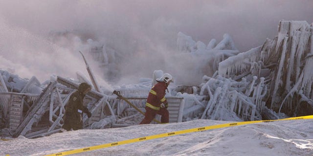 Jan. 23, 2014: Firefighters work at the scene of a senior's residence fire in L'Isle-Verte, Quebec.