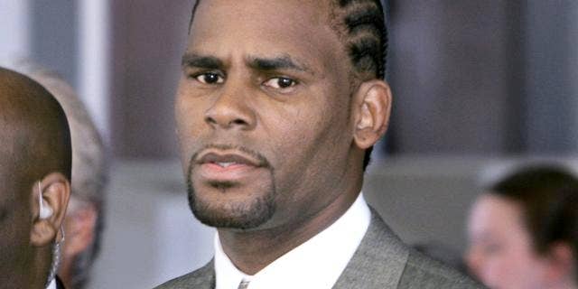 R&B singer R. Kelly, right, arrives for a court appearance Friday, July 1, 2005, in Chicago, where a judge set a court date to determine the age of the tape in the R. Kelly case. Kelly is accused of videotaping himself engaging in sex acts with an apparently underage girl at a home he owns in Chicago. He has pleaded innocent. (AP Photo/Charles Rex Arbogast)