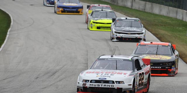 ELKHART LAKE, W.I. - JUNE 21: Alex Tagliani, driver of the #22 Discount Tire Ford, leads a pack of cars during the NASCAR Nationwide Series Gardner Denver 200 Fired Up by Johnsonville at Road America, June 21, 2014 in Elkhart Lake, Wisconsin. (Photo by Rainier Ehrhardt/Getty Images)