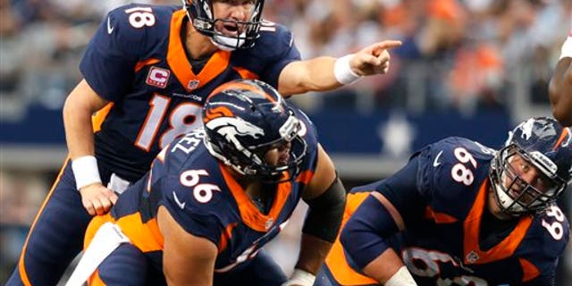 In this Oct. 6, 2013, photo, Denver Broncos quarterback Peyton Manning (18), center Manny Ramirez (66) and guard Zane Beadles (68) get ready for a play during an NFL football game against the Dallas Cowboys in Arlington, Texas. The man in the middle of Denver's offensive line, the one that's allowed the fewest sacks in the league, is the center who had never started a game at the position before this season. (AP Photo/Sharon Ellman)
