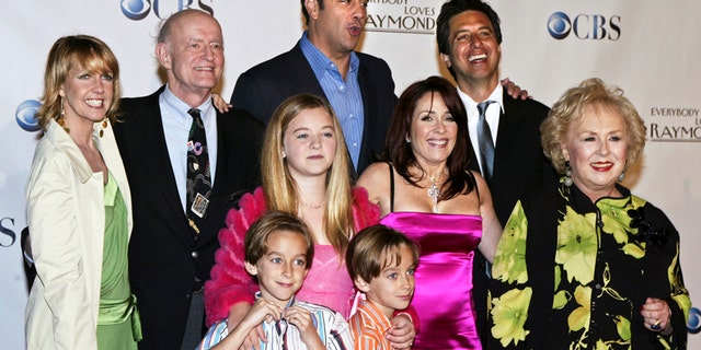 Cast members of "Everybody Loves Raymond," (back L-R) Monica Horan, Peter Boyle, Brad Garrett, Ray Romano, (middle L-R) Madylin Sweeten, Patricia Heaton, Doris Roberts, (front L-R) Sawyer Sweeten and Sullivan Sweeten, pose for a group photo at the series wrap party in Santa Monica, California April 28, 2005.