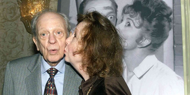 Actor Don Knotts is kissed by actress Betty Lynn who portrayed Fife's girlfriend Thelma as they recreate a pose from a publicity photograph in this January 19, 2000 file photo.