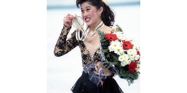 U.S.A's Olympic figure skater Kristi Yamaguchi, 21, of San Francisco, Ca., shows off her gold medal in Albertville on February 21, 1992.