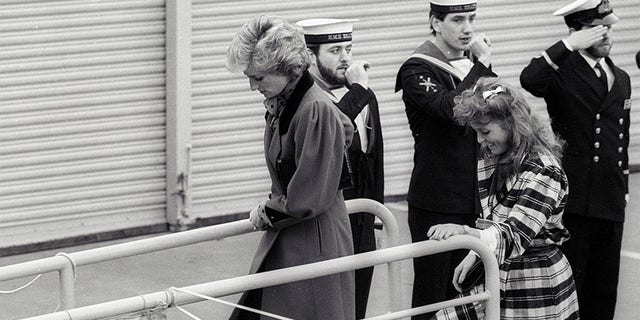 Princess Diana (L) and Sarah Ferguson board the HMS Brazen, which is moored in the pool of London on February 5, 1986.