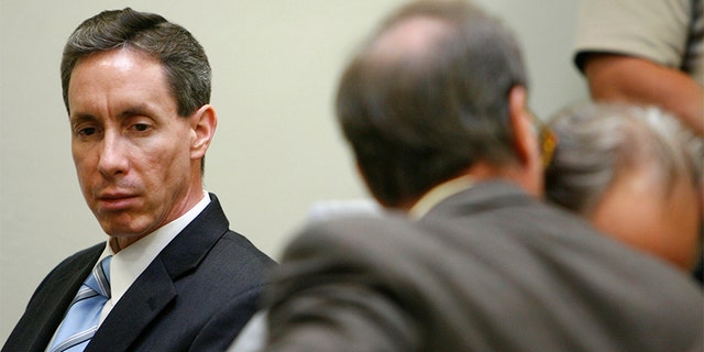 Warren Jeffs (L) looks at his attorney during his trial in St. George, Utah, September 19, 2007. A Utah judge rejected a motion to dismiss charges against a self-described "prophet" of a breakaway Mormon sect that practices polygamy after prosecutors rested their case unexpectedly early on Tuesday. Warren Jeffs, 51, the leader of the Fundamentalist Church of Jesus Christ of Latter Day Saints, is on trial on two counts of being an accomplice to rape after he presided over a wedding of a 14-year-old girl.