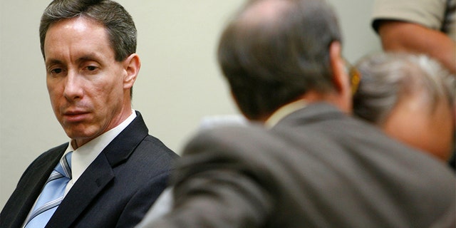 Warren Jeffs (L) looks at his attorney during his trial in St. George, Utah, September 19, 2007. A Utah judge rejected a motion to dismiss charges against a self-described "prophet" of a breakaway Mormon sect that practices polygamy after prosecutors rested their case unexpectedly early on Tuesday. Warren Jeffs, 51, the leader of the Fundamentalist Church of Jesus Christ of Latter Day Saints, is on trial on two counts of being an accomplice to rape after he presided over a wedding of a 14-year-old girl.