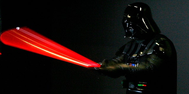A man dressed as Star Wars character Darth Vader poses for photographers at the "Star Wars: Where Science Meets Imagination" exhibition at the Powerhouse Museum in Sydney December 3, 2008.