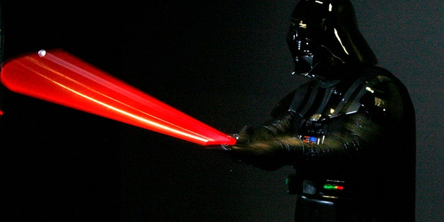 A man dressed as Star Wars character Darth Vader poses for photographers at the "Star Wars: Where Science Meets Imagination" exhibition at the Powerhouse Museum in Sydney December 3, 2008.