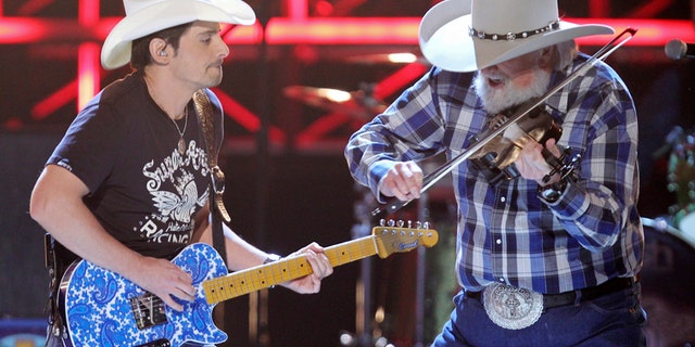 Brad Paisley (L) and Charlie Daniels perform "Travelin' Band" at the 45th annual Academy of Country Music Awards in Las Vegas, Nevada, April 18, 2010. REUTERS/Robert Galbraith (UNITED STATES - Tags: ENTERTAINMENT) - RTR2CZRD