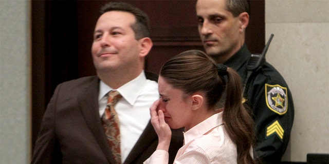Casey Anthony cries next to her attorney Jose Baez (L) after she was acquitted on first-degree murder charges of her daughter Caylee at the Orange County Courthouse Orlando, Florida July 5, 2011.