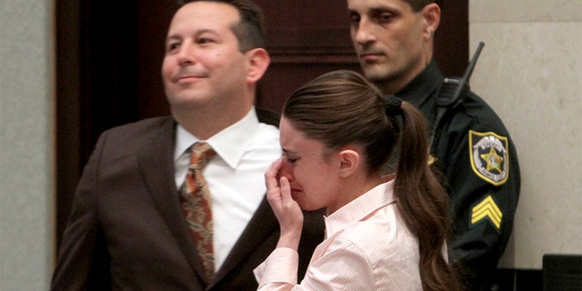 Casey Anthony cries next to her attorney Jose Baez (L) after she was acquitted on first-degree murder charges of her daughter Caylee at the Orange County Courthouse Orlando, Florida July 5, 2011.
