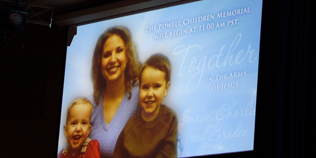 A picture of Susan Powell is seen on a screen with her children Charles (R) and Braden Powell during funeral services for the boys in Tacoma, Wash., Feb. 11, 2012.