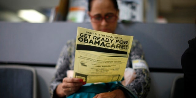 Arminda Murillo, 54, reads a leaflet at a health insurance enrollment event in Cudahy, California March 27, 2014. More than 6 million people have now signed up for private insurance plans under President Barack Obama's signature healthcare law known as Ob