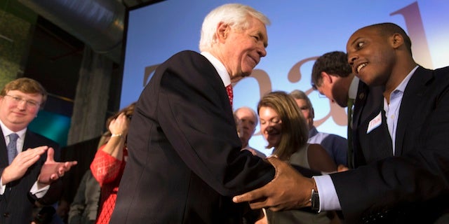 Republican U.S. Senator Thad Cochran greets supporter Marcus Ward (R) during an election night celebration after defeating Tea Party challenger Chris McDaniel in a run-off election in Jackson, Mississippi June 24, 2014. REUTERS/Lee Celano (UNITED STATES - Tags: POLITICS ELECTIONS) - RTR3VLJF