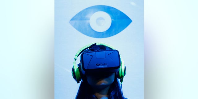 A woman tries out out Oculus VR's headset Oculus rift development kit 2 at its booth in Tokyo Game Show 2014 in Makuhari, east of Tokyo September 18, 2014.